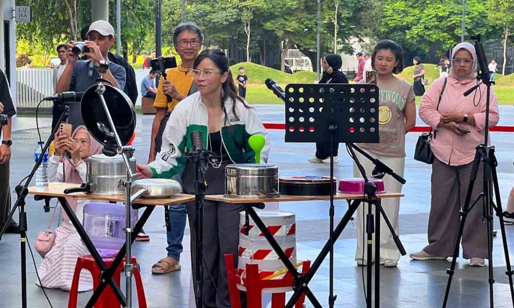 Marissa Sutanto memperagakan permainan drum panci menggunakan centong kayu dalam acara komunitas musik.
